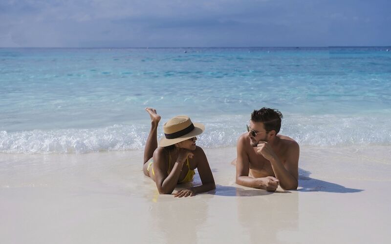 Couple lying in turquoise shallows