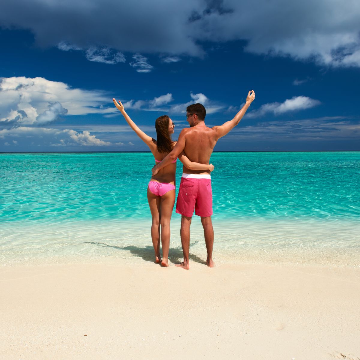 Happy couple relaxing on the beach